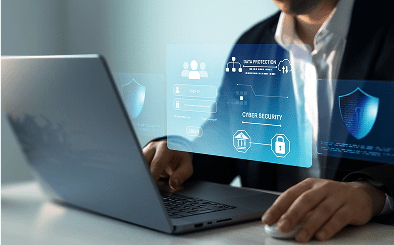 Person working on laptop with cybersecurity hologram.